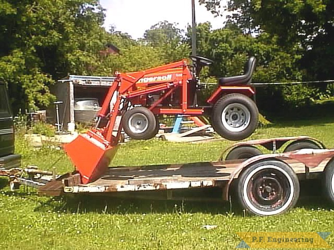 this shows how strong a side mount sub frame design is to hold up the entire tractor. notice how the bucket is chained to the trailer.  | Ingersoll LGT 318 garden tractor loader_3