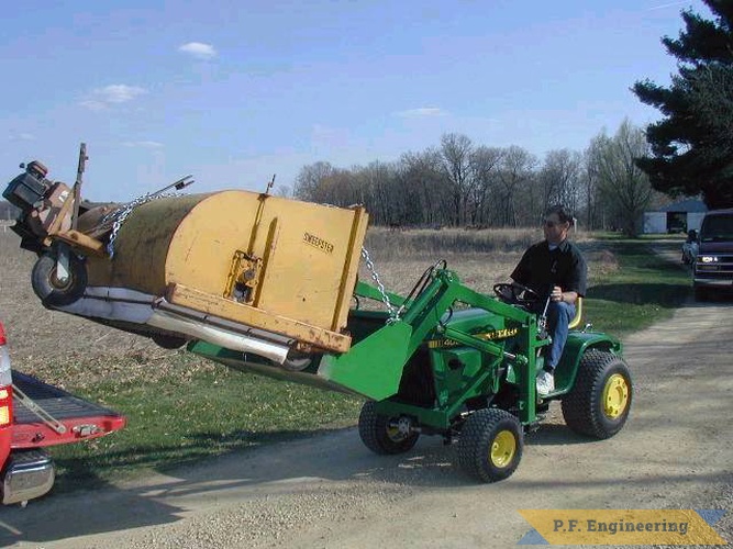 here Al is lifting a sweepster broom unit onto the back of a pickup. that 350 lbs of counterweight comes in handy at times like this. | John Deere 400 Garden Tractor Loader_1
