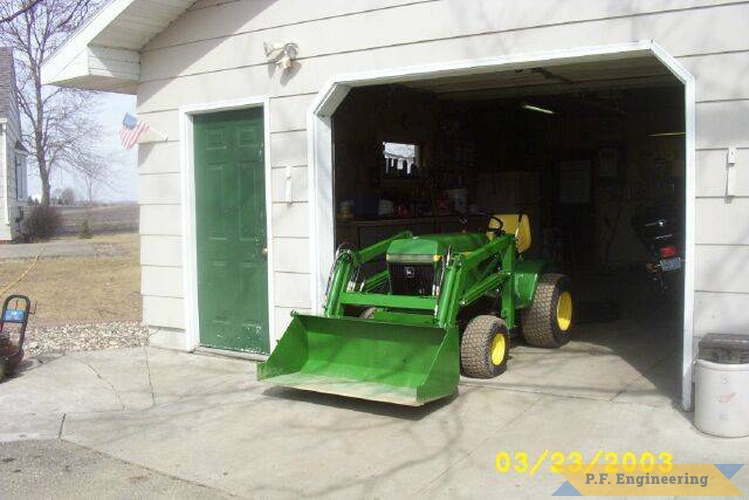 the John Deere 400 waiting patiently in the garage for it's next job. | John Deere 400 Garden Tractor Loader_2